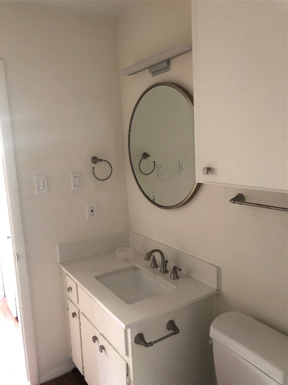 bathroom featuring vanity and toilet