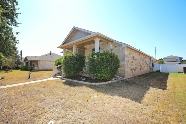 view of side of property with a lawn