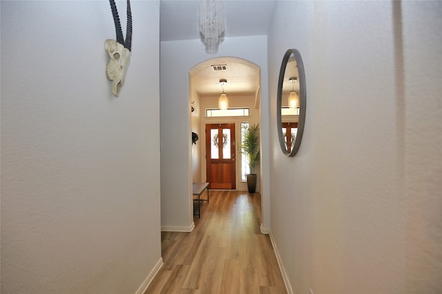 hall with light hardwood / wood-style floors