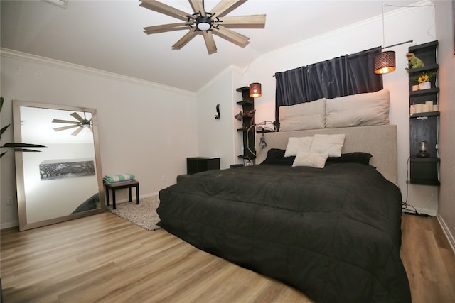 bedroom featuring ceiling fan, ornamental molding, and hardwood / wood-style floors