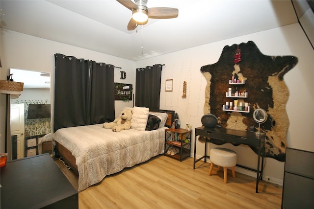 bedroom with hardwood / wood-style flooring and ceiling fan