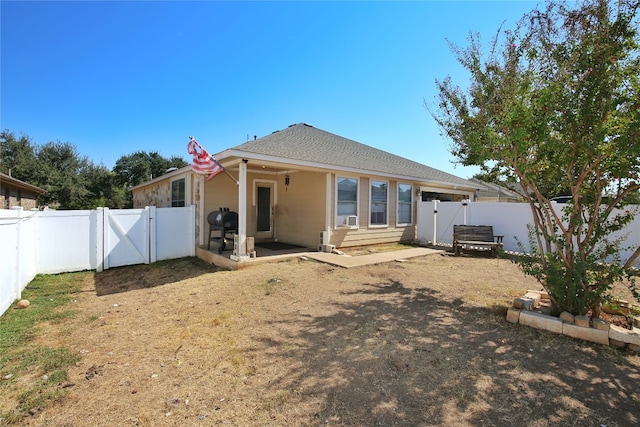 back of property with cooling unit and a patio