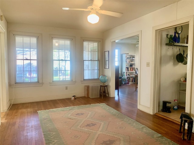 doorway to outside featuring dark wood-type flooring and ceiling fan