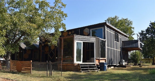 rear view of property with a yard