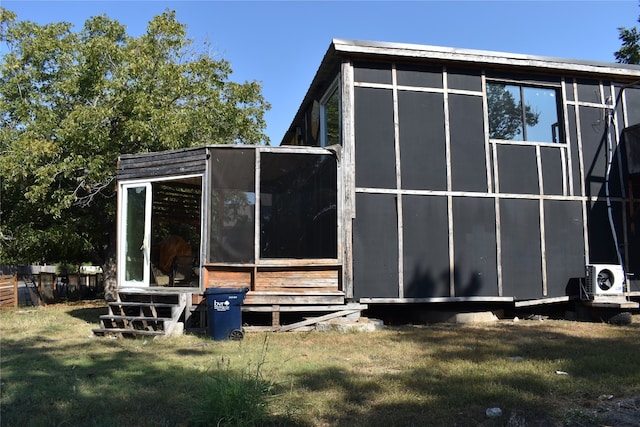 exterior space featuring a yard and ac unit