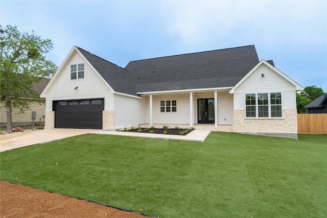 modern inspired farmhouse featuring a front yard and a garage