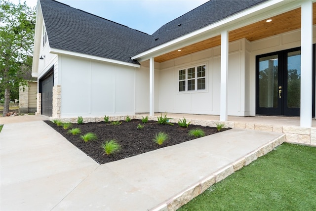 doorway to property with french doors and a garage