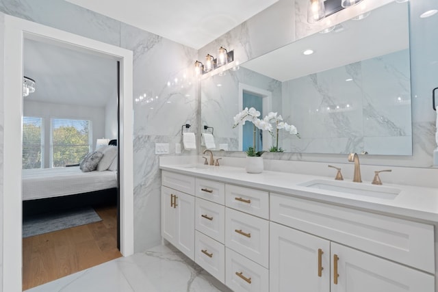 bathroom featuring vanity and tile walls