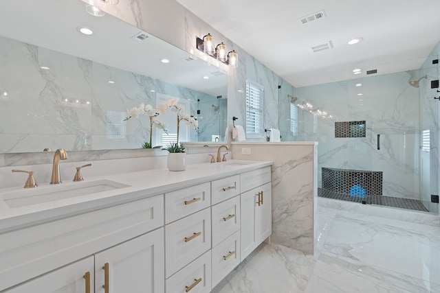 bathroom featuring vanity and a shower with shower door