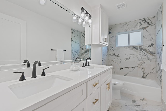 full bathroom featuring vanity, tiled shower / bath combo, and toilet