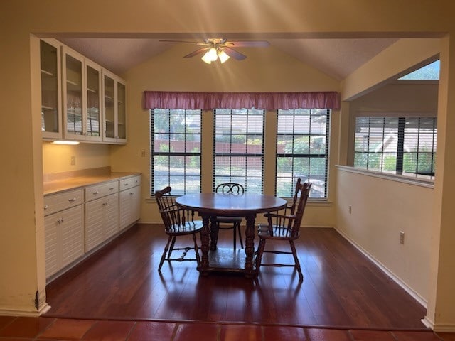 dining room featuring ceiling fan, vaulted ceiling, and dark hardwood / wood-style flooring