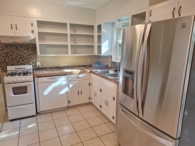 kitchen with white cabinets, white appliances, backsplash, and light tile patterned floors