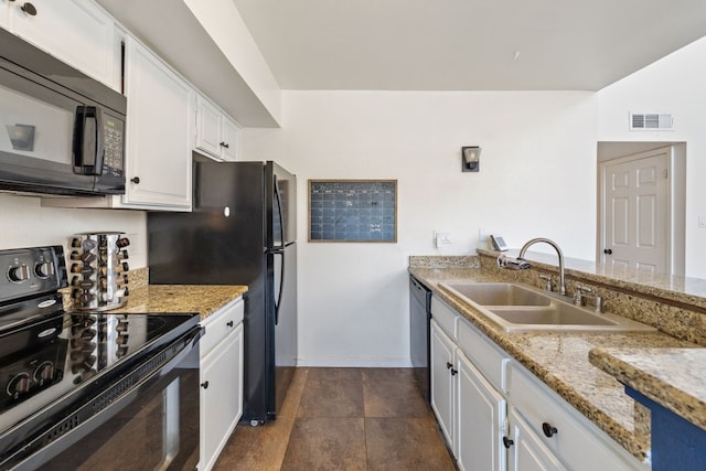 kitchen with light stone counters, sink, black appliances, and white cabinets