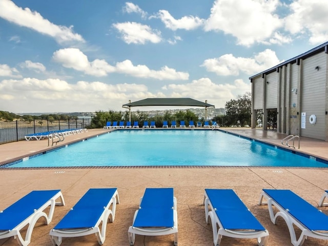 community pool featuring a patio area and fence