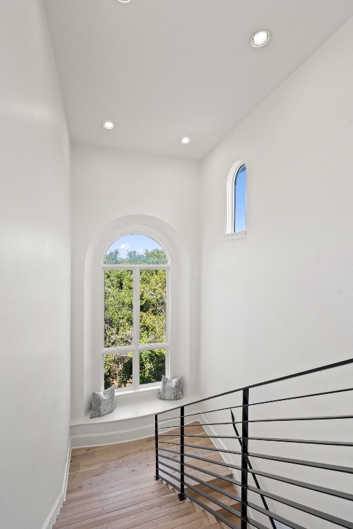 stairway with hardwood / wood-style flooring