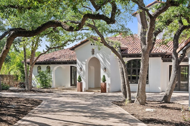 mediterranean / spanish house featuring french doors and a patio area