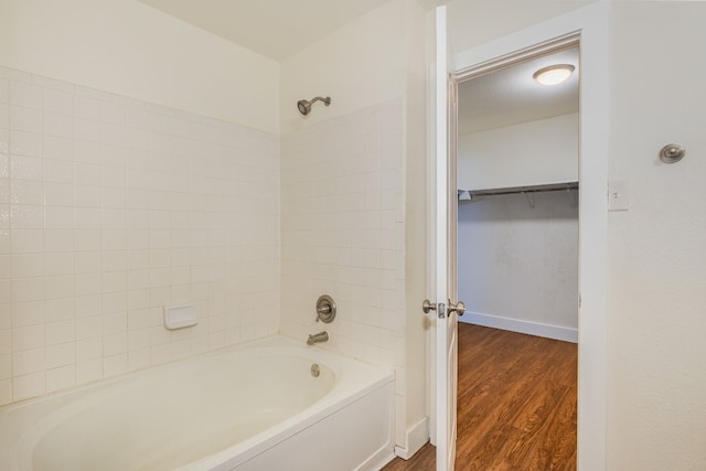 bathroom with tiled shower / bath and hardwood / wood-style flooring