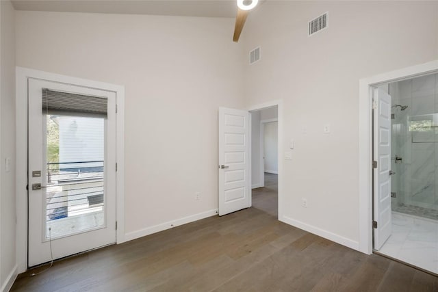 909 Capitol Ct Unit 2, Austin, TX 78756 - unfurnished bedroom with wood finished floors, high vaulted ceiling, and ensuite bath