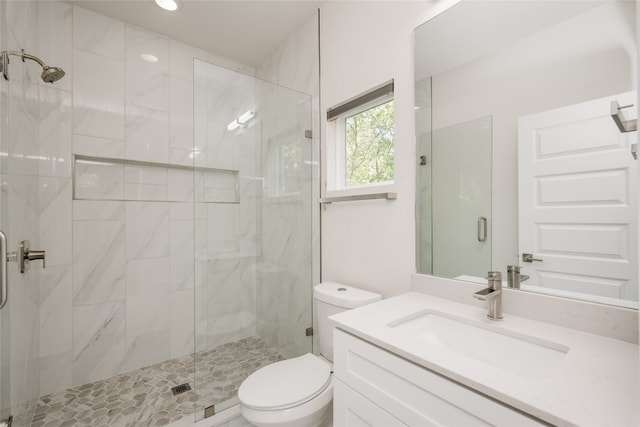 bathroom featuring walk in shower, vanity, and toilet