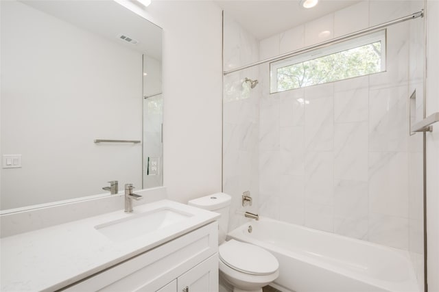 full bathroom featuring toilet, vanity, and tiled shower / bath