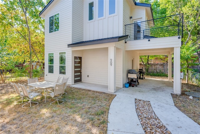 back of property with a balcony and a patio area