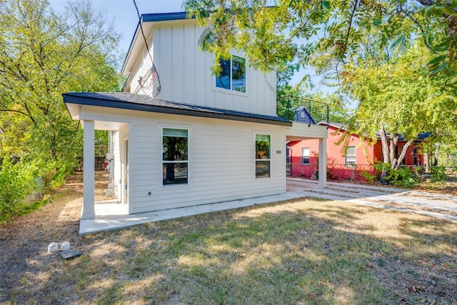 rear view of house featuring a yard and a patio