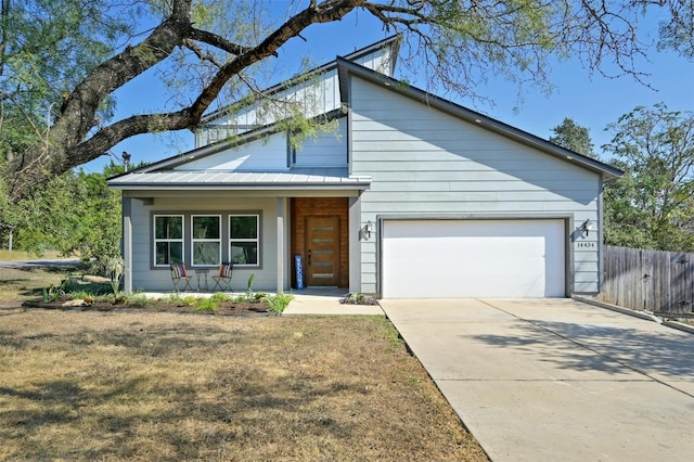 view of front of home featuring a porch, a garage, and a front lawn