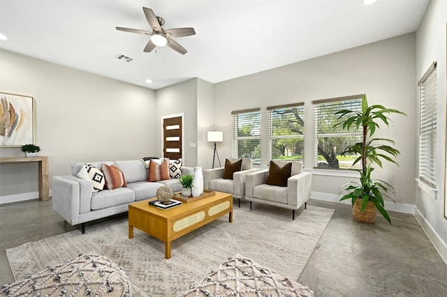 living room with concrete floors and ceiling fan