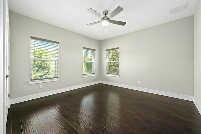 empty room featuring dark hardwood / wood-style flooring and ceiling fan