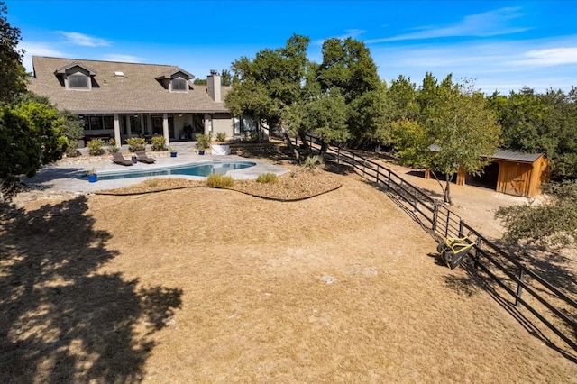 exterior space featuring a storage shed and a patio