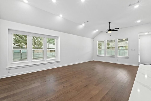 interior space with dark hardwood / wood-style flooring, vaulted ceiling, plenty of natural light, and ceiling fan