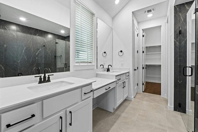 bathroom with vanity, tile patterned floors, an enclosed shower, and lofted ceiling