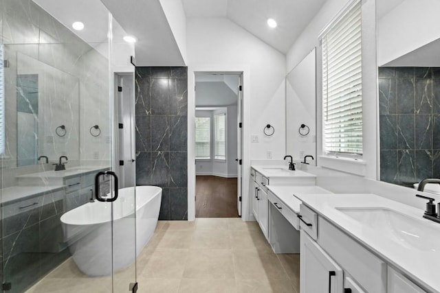 bathroom with shower with separate bathtub, vanity, lofted ceiling, and hardwood / wood-style flooring