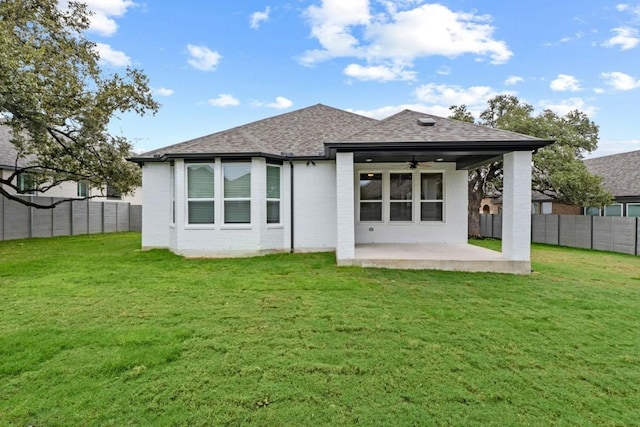 rear view of house with a patio area, ceiling fan, and a yard