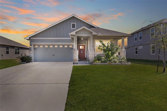 view of front of home featuring a garage and a lawn