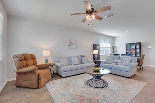 living room featuring ceiling fan and light hardwood / wood-style flooring