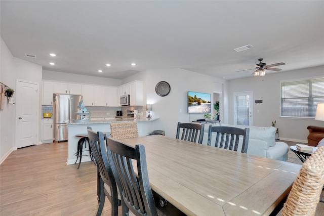 dining space featuring ceiling fan and light hardwood / wood-style flooring