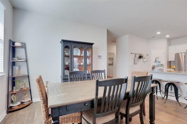 dining space featuring light hardwood / wood-style floors