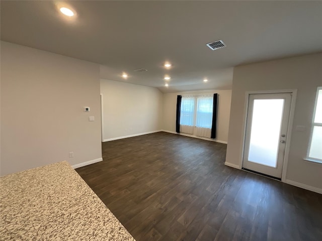 unfurnished room with dark wood-type flooring