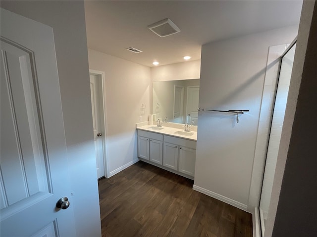 bathroom featuring vanity, an enclosed shower, and hardwood / wood-style flooring