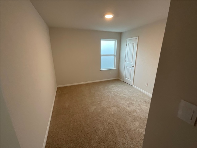 empty room featuring light colored carpet