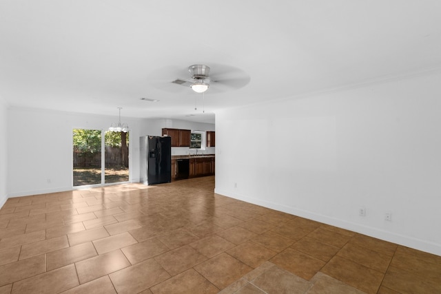 unfurnished living room featuring ceiling fan with notable chandelier and light tile patterned floors