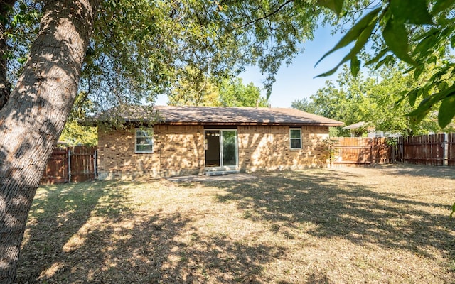 back of house with a lawn