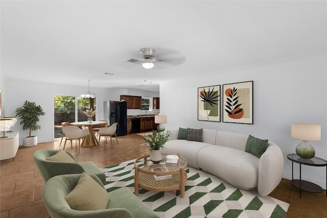 living room with light tile patterned floors and ceiling fan with notable chandelier