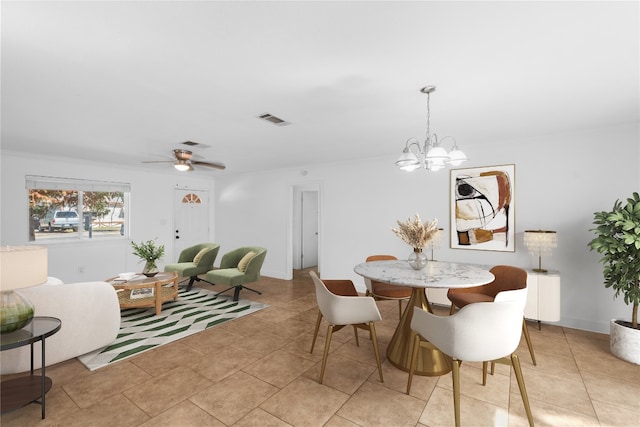 dining room with ceiling fan with notable chandelier