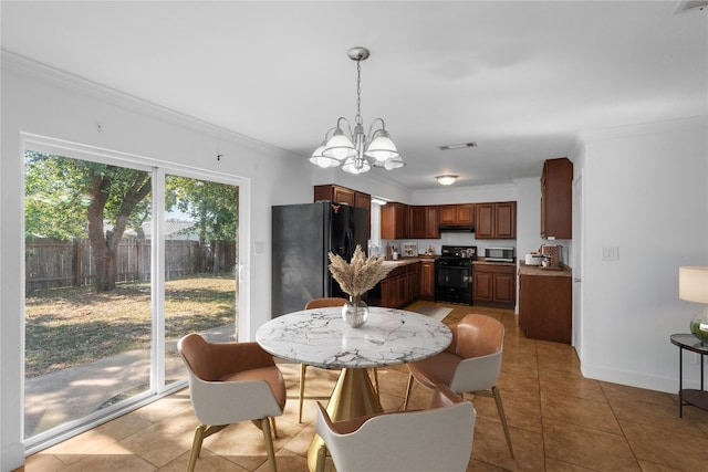 dining area featuring ornamental molding, sink, a notable chandelier, and tile patterned floors