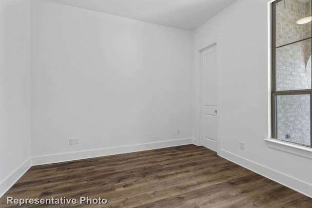 unfurnished room featuring dark hardwood / wood-style floors