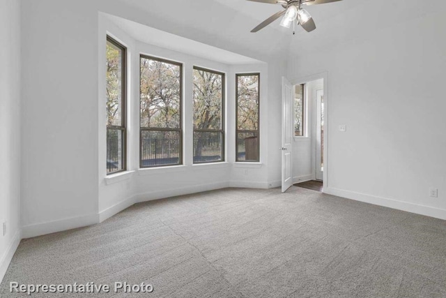 spare room featuring carpet and ceiling fan