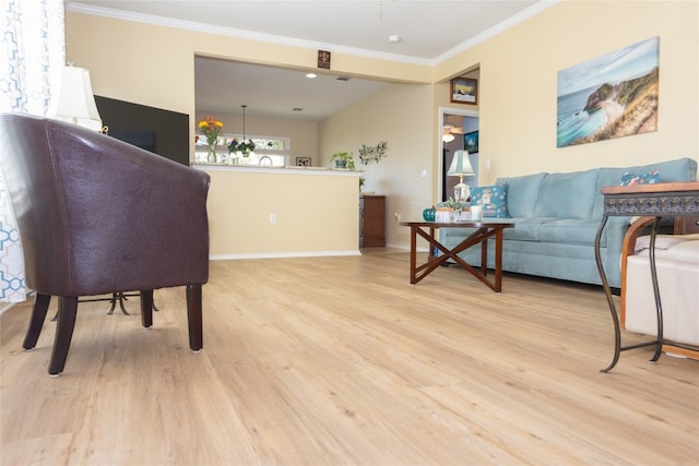 living room with light wood-type flooring and ornamental molding