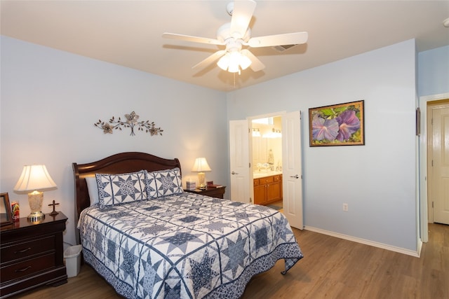 bedroom featuring hardwood / wood-style flooring, ceiling fan, and connected bathroom